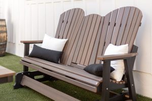 Comfo Back Three Seat Glider with middle console in Brazilian Walnut on Black. Throw pillows in Canvas atural and Canvas Black Comfo Back Three Seat Glider with middle console in Brazilian Walnut on Black. Throw pillows in Canvas atural and Canvas Black